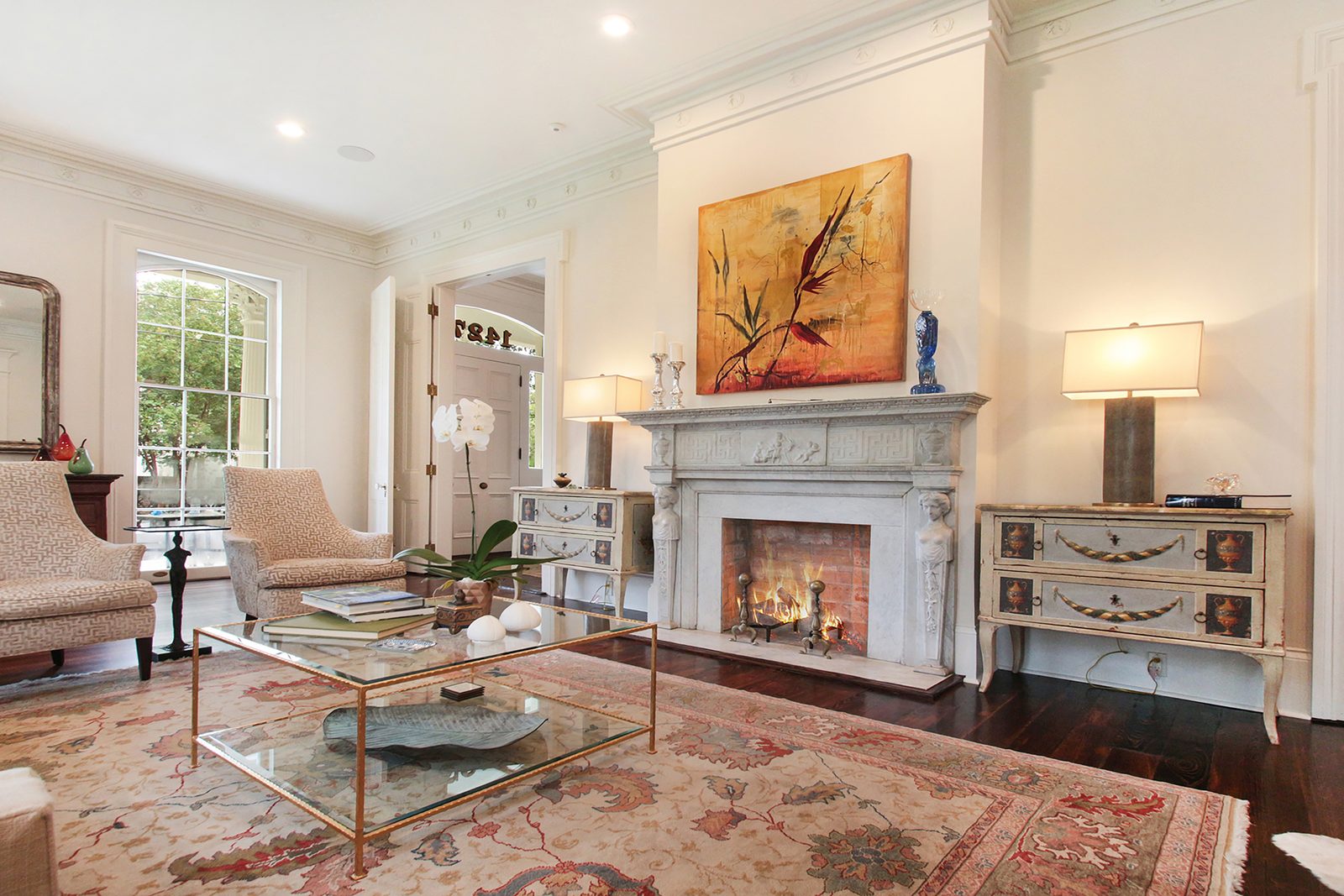 Restored salon with carved mantel after whole-home renovation in the Garden District