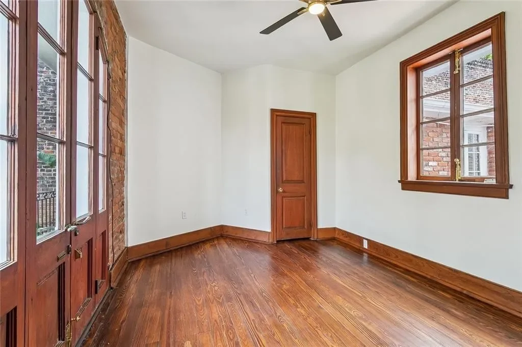 Bedroom with French doors — historic Esplanade Avenue building renovated by DuCar Construction, New Orleans