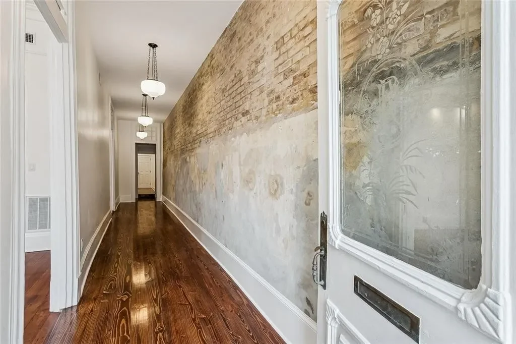 Hall with the original wall exposed — historic Esplanade Avenue building renovated by DuCar Construction, New Orleans