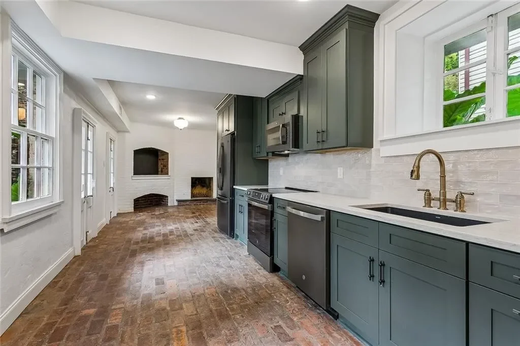 Ground-floor kitchen on old brick — historic Esplanade Avenue building renovated by DuCar Construction, New Orleans