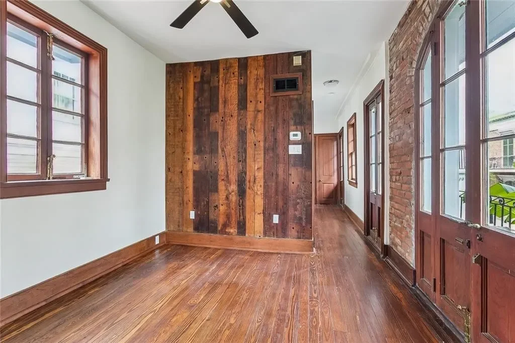 Reclaimed wood wall and French doors — historic Esplanade Avenue building renovated by DuCar Construction, New Orleans