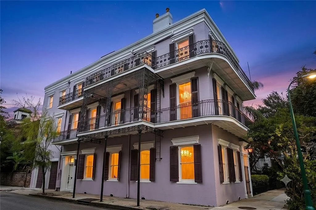 The building at dusk, galleries lit — Esplanade Avenue, French Quarter, renovated by DuCar Construction