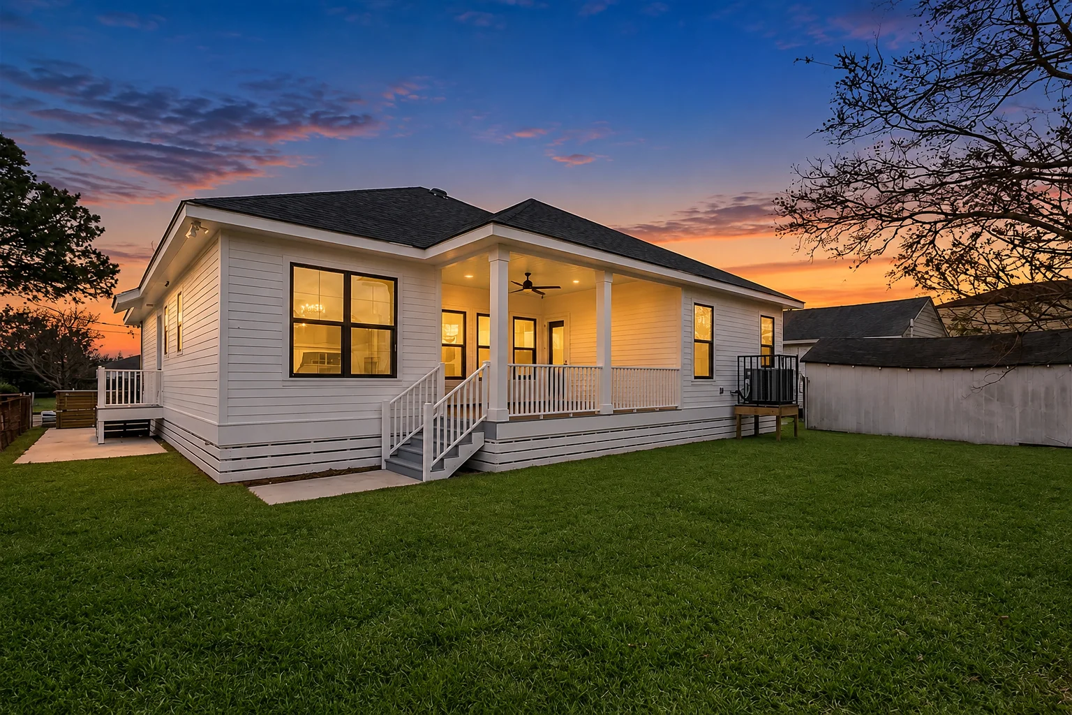 New raised home with back porch and fenced backyard, built by DuCar Construction in New Orleans