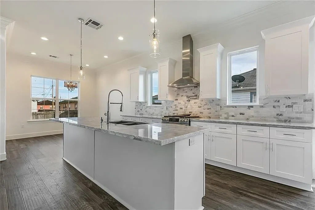 Modern kitchen with island and quartz countertops in a new DuCar home