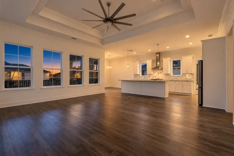 Open living room and kitchen under an 11-foot tray ceiling in a DuCar new home in New Orleans