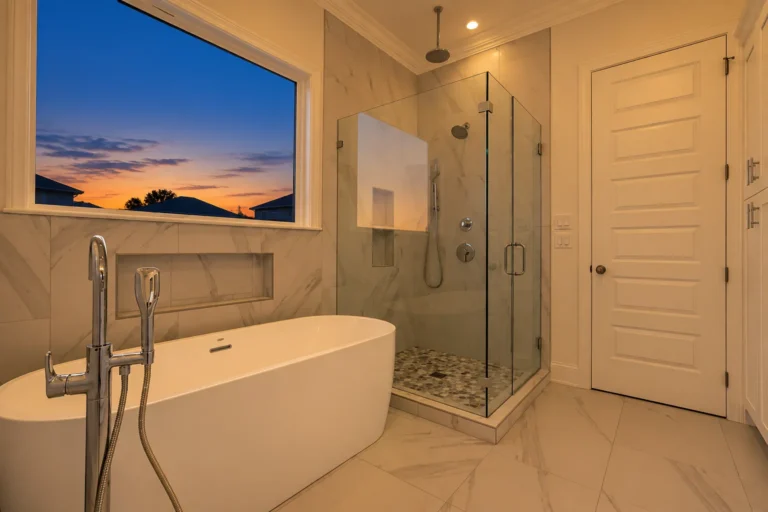 Freestanding tub and frameless glass shower in the primary bath of a DuCar new home in New Orleans