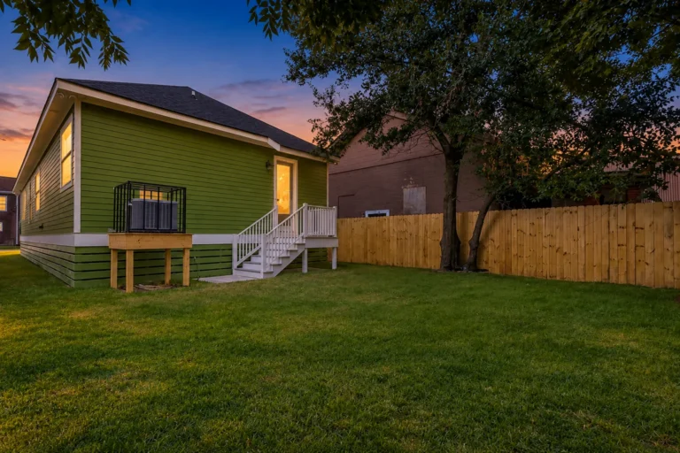 Back of a DuCar new-construction home in New Orleans with a raised equipment platform and a fenced yard
